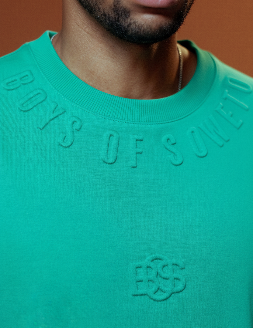 Turquoise Boys of Soweto T-shirt with terracotta background